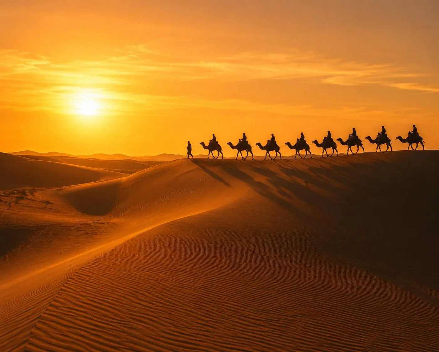 Camel caravan crossing dunes at sunset